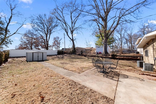 view of yard with a storage unit, a patio area, cooling unit, a fenced backyard, and an outdoor structure