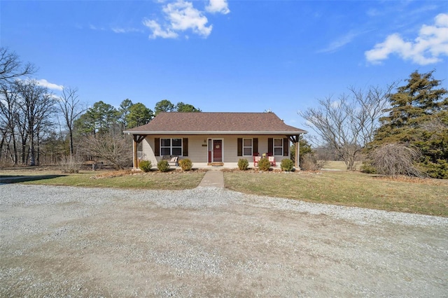 view of front of home featuring a porch, driveway, and a front lawn