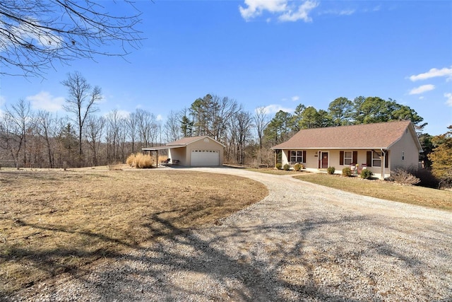 ranch-style home with gravel driveway and covered porch