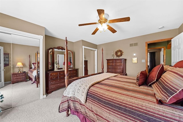 bedroom with a ceiling fan, a closet, visible vents, and light carpet