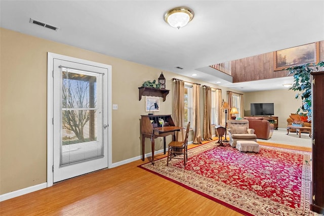 sitting room featuring a wealth of natural light, baseboards, visible vents, and wood finished floors