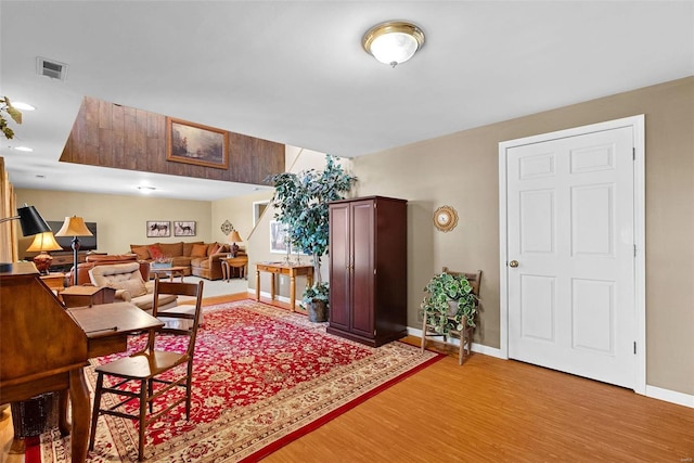 dining room featuring light wood-type flooring, visible vents, and baseboards