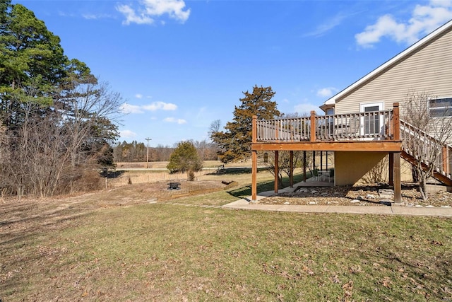 view of yard featuring a deck and stairs