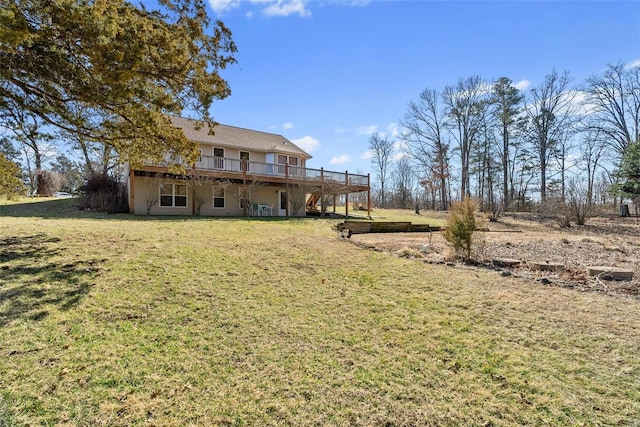 back of property with a yard and a wooden deck