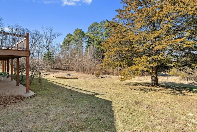 view of yard featuring a deck and a patio