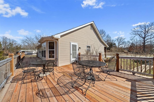 wooden deck featuring outdoor dining area