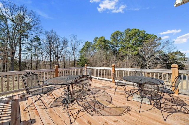 wooden terrace featuring outdoor dining area