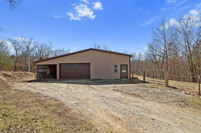 view of home's exterior featuring a garage, an outdoor structure, and fence