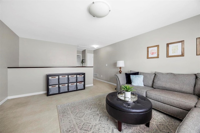 living room featuring visible vents, baseboards, and light colored carpet