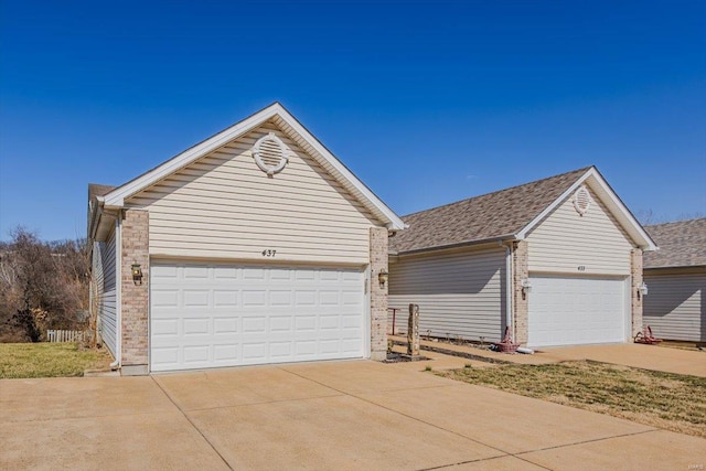 single story home featuring a garage, brick siding, and roof with shingles