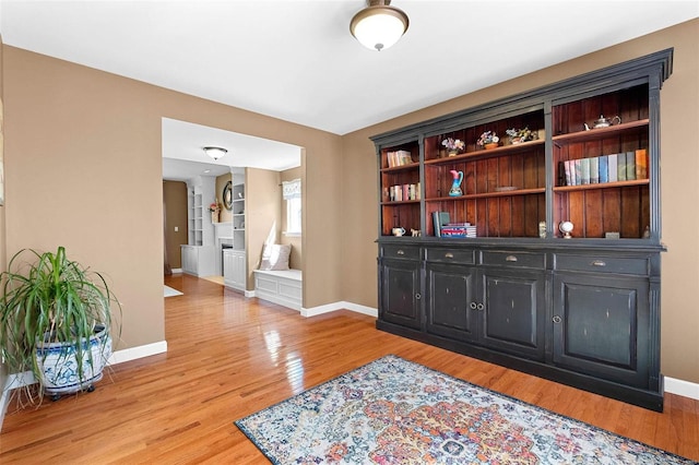 sitting room with light wood-type flooring and baseboards