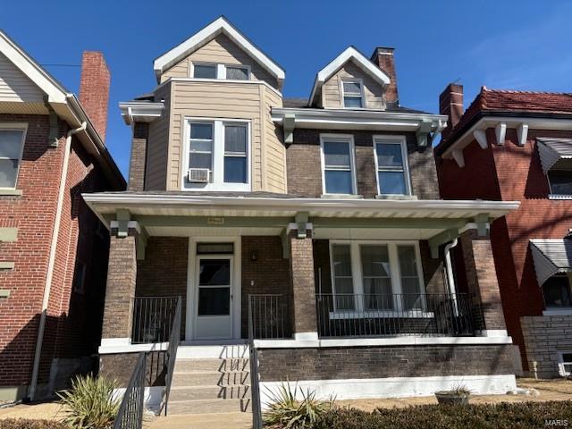 view of front facade featuring covered porch and brick siding