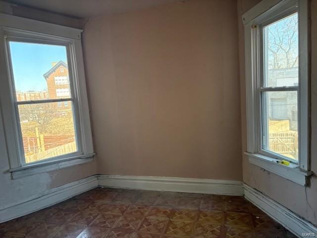 empty room with baseboard heating and baseboards