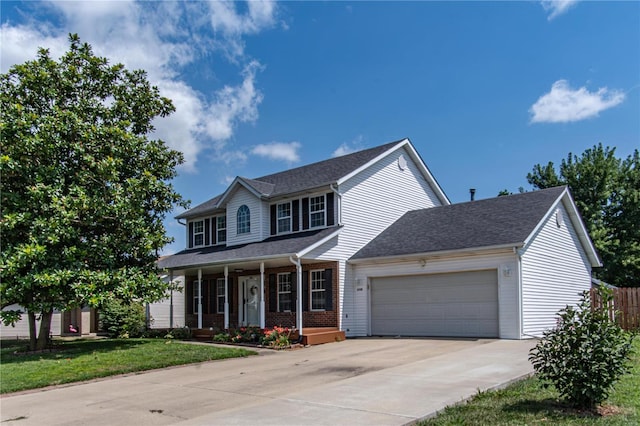 view of front of property with brick siding, a porch, a front yard, a garage, and driveway