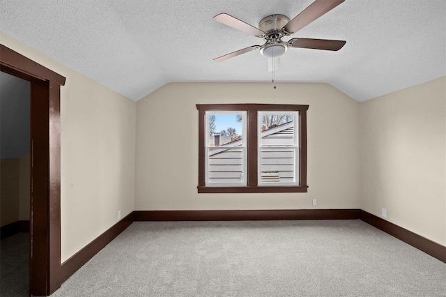 bonus room with lofted ceiling, a textured ceiling, and carpet