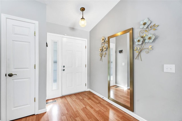 foyer entrance featuring light wood-type flooring, visible vents, and baseboards