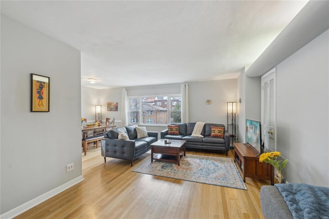 living area with light wood finished floors and baseboards