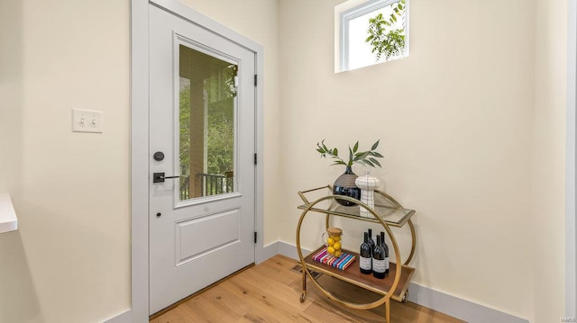 entryway with light wood-style flooring and baseboards