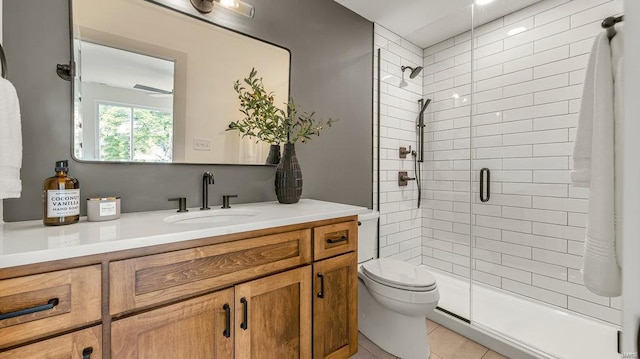 bathroom with toilet, a stall shower, tile patterned flooring, and vanity