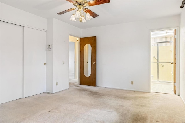 unfurnished bedroom with a ceiling fan, carpet, a closet, and connected bathroom