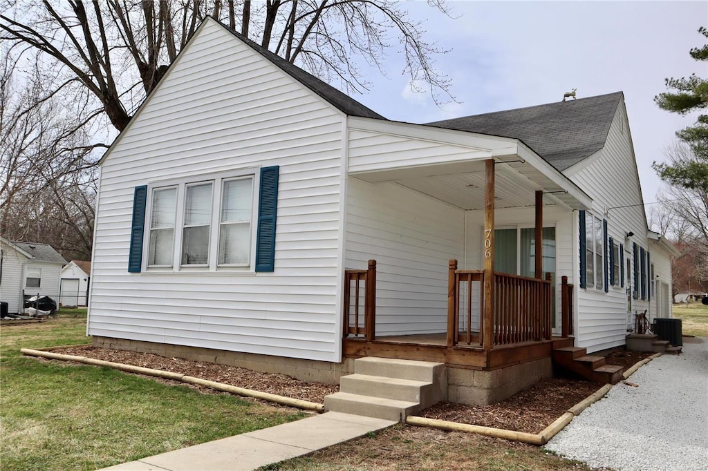 view of front of house with a porch and roof with shingles