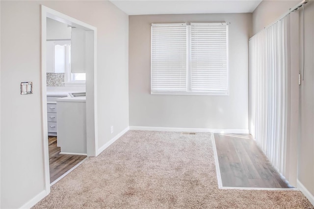 unfurnished bedroom featuring carpet and baseboards