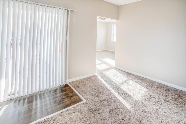 empty room featuring wood finished floors and baseboards