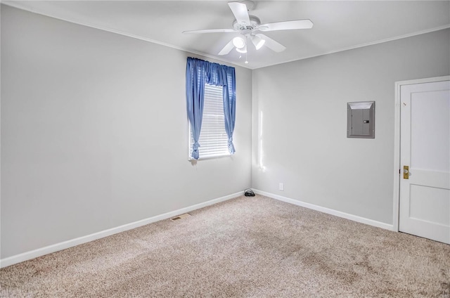 empty room featuring visible vents, baseboards, carpet floors, electric panel, and ceiling fan