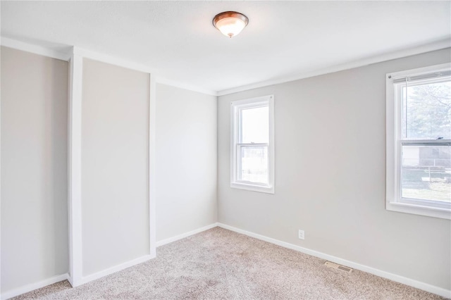 spare room featuring visible vents, baseboards, and carpet