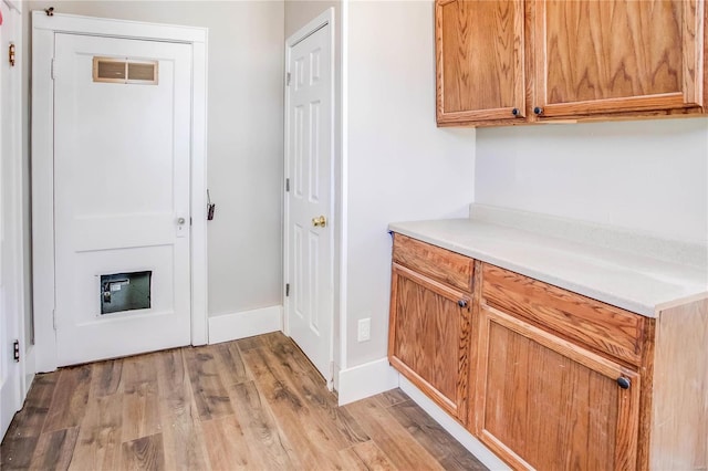 interior space featuring visible vents, baseboards, and light wood-style floors