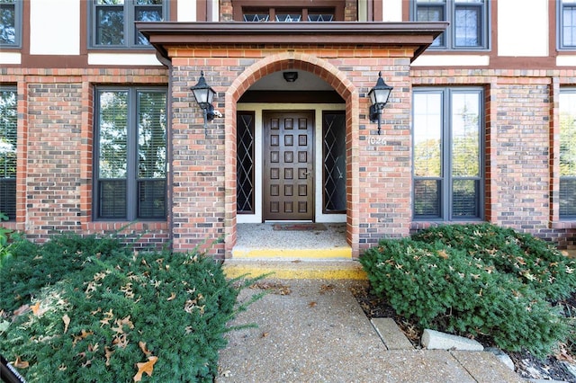 doorway to property with brick siding