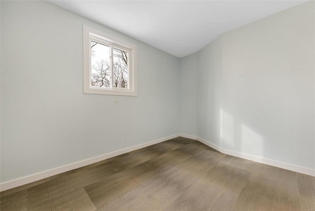 unfurnished room with baseboards