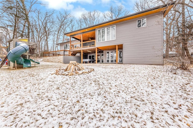 snow covered property featuring a playground