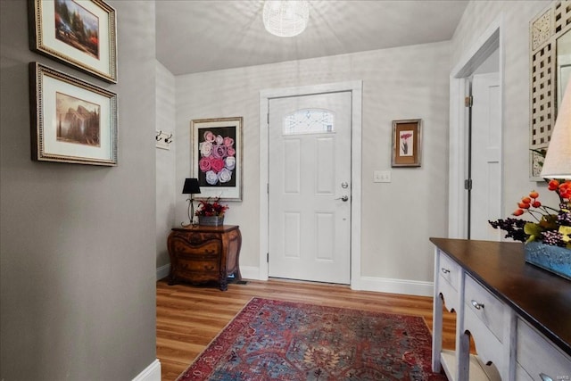 entryway with wood finished floors and baseboards