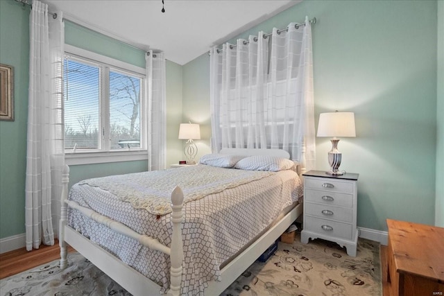 bedroom featuring baseboards and wood finished floors