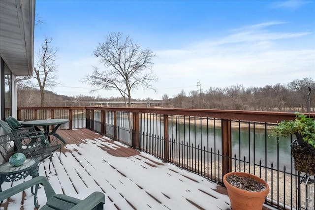 wooden deck featuring a water view and fence