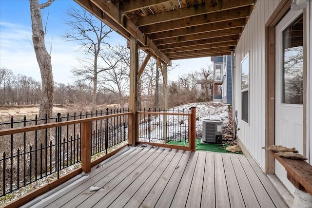 wooden terrace with cooling unit and fence