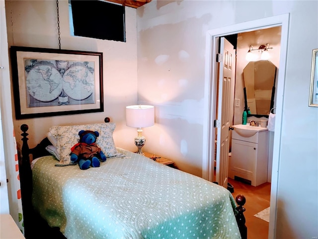 carpeted bedroom featuring a sink and connected bathroom