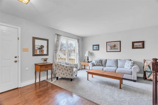 living area with wood finished floors and baseboards