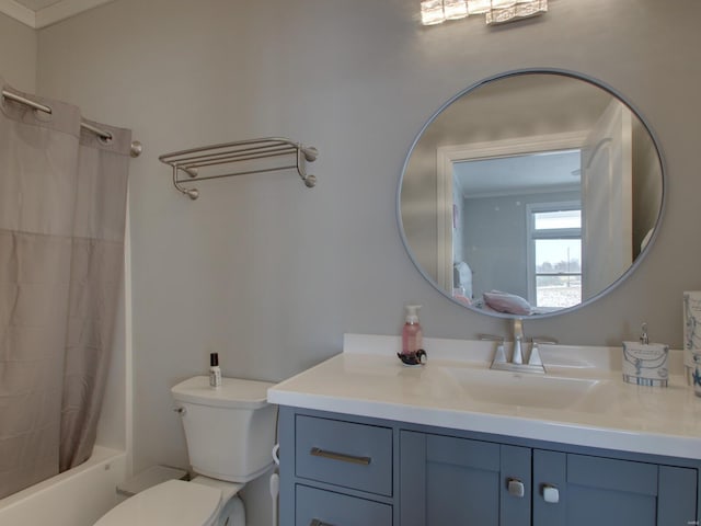 full bathroom featuring vanity, shower / bath combo with shower curtain, toilet, and crown molding