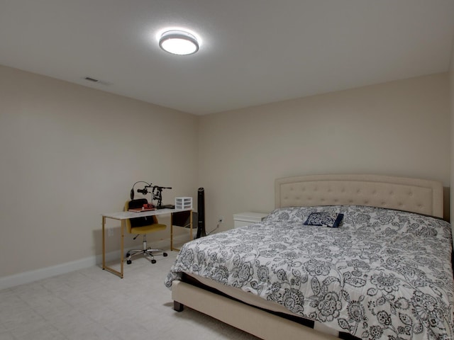 bedroom with baseboards and tile patterned floors