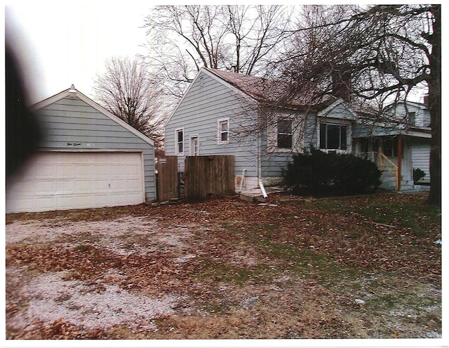 view of side of property with a garage and fence