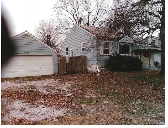 view of side of property with a garage and fence