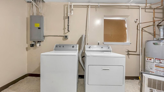 washroom with gas water heater, laundry area, baseboards, electric panel, and washing machine and clothes dryer