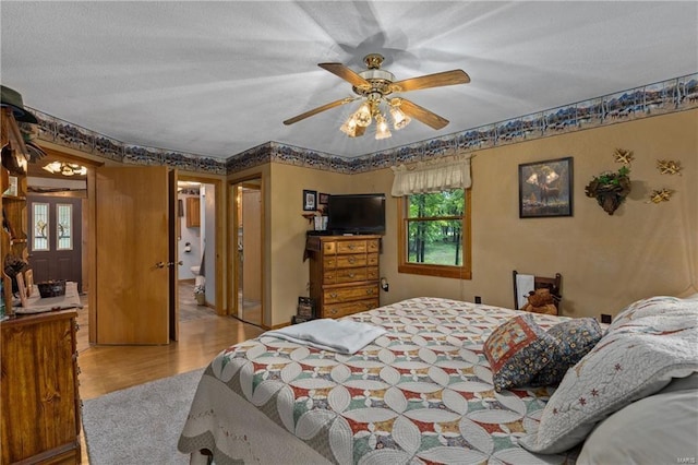 bedroom with light wood-style flooring and a ceiling fan