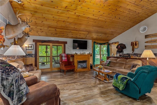 living room with visible vents, a glass covered fireplace, wood ceiling, wood finished floors, and high vaulted ceiling