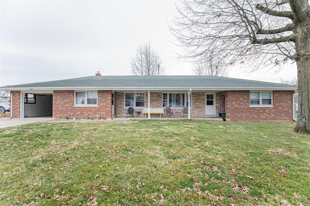 single story home with driveway, a chimney, an attached carport, and a front yard