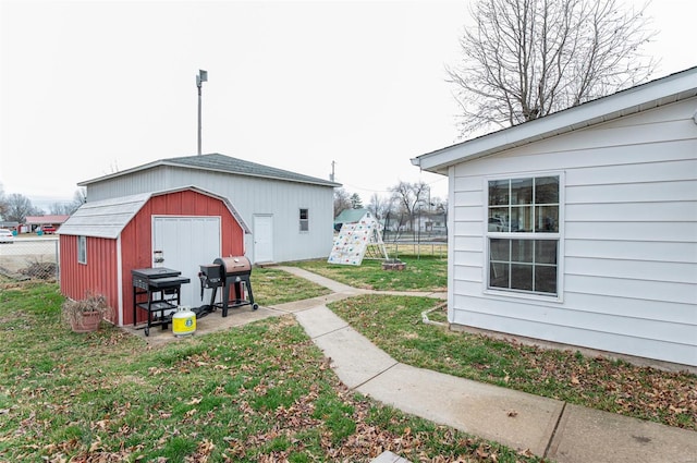 view of yard with a storage shed, fence, and an outdoor structure