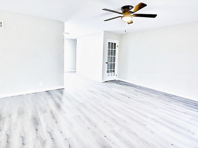 unfurnished room with light wood-style floors, visible vents, ceiling fan, and baseboards