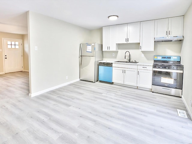 kitchen featuring stainless steel appliances, light countertops, white cabinets, a sink, and under cabinet range hood